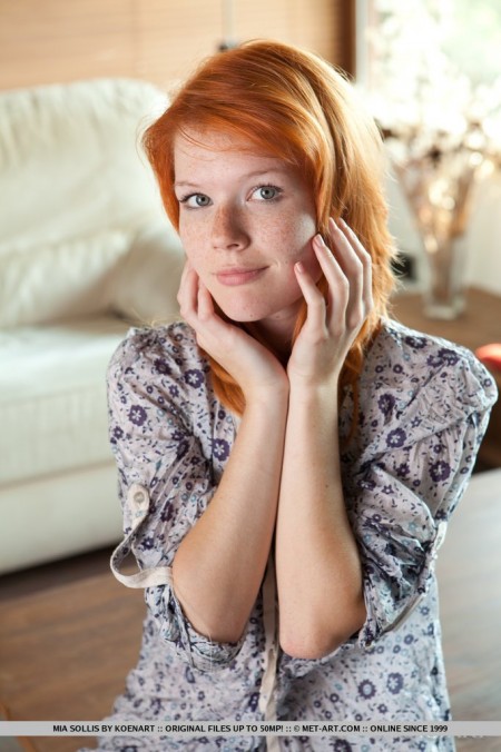 The redhead chick Mia Sollis has climbed the table and stretched legs showing nude pussy